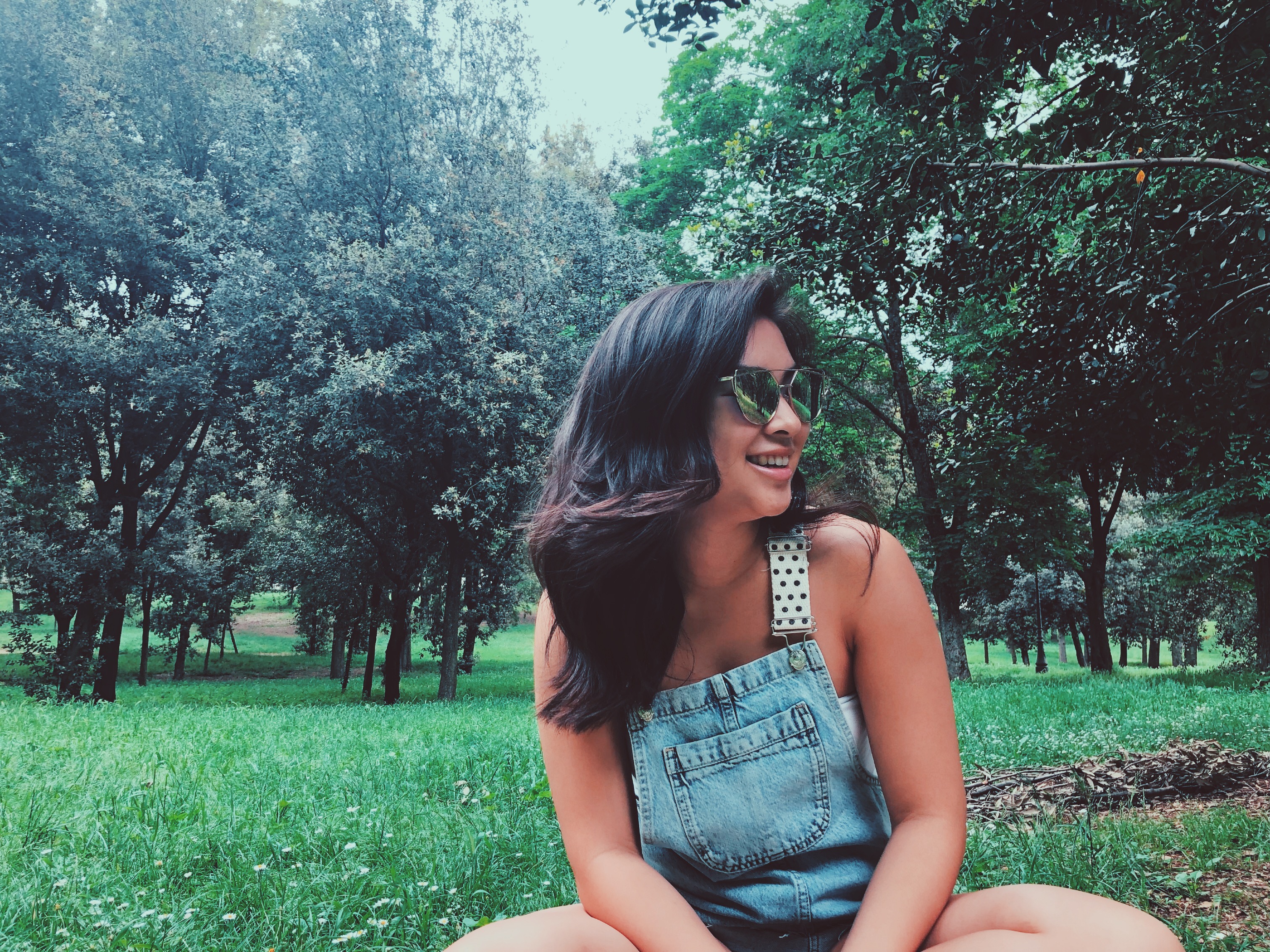 ang around the globe in overalls sitting in park