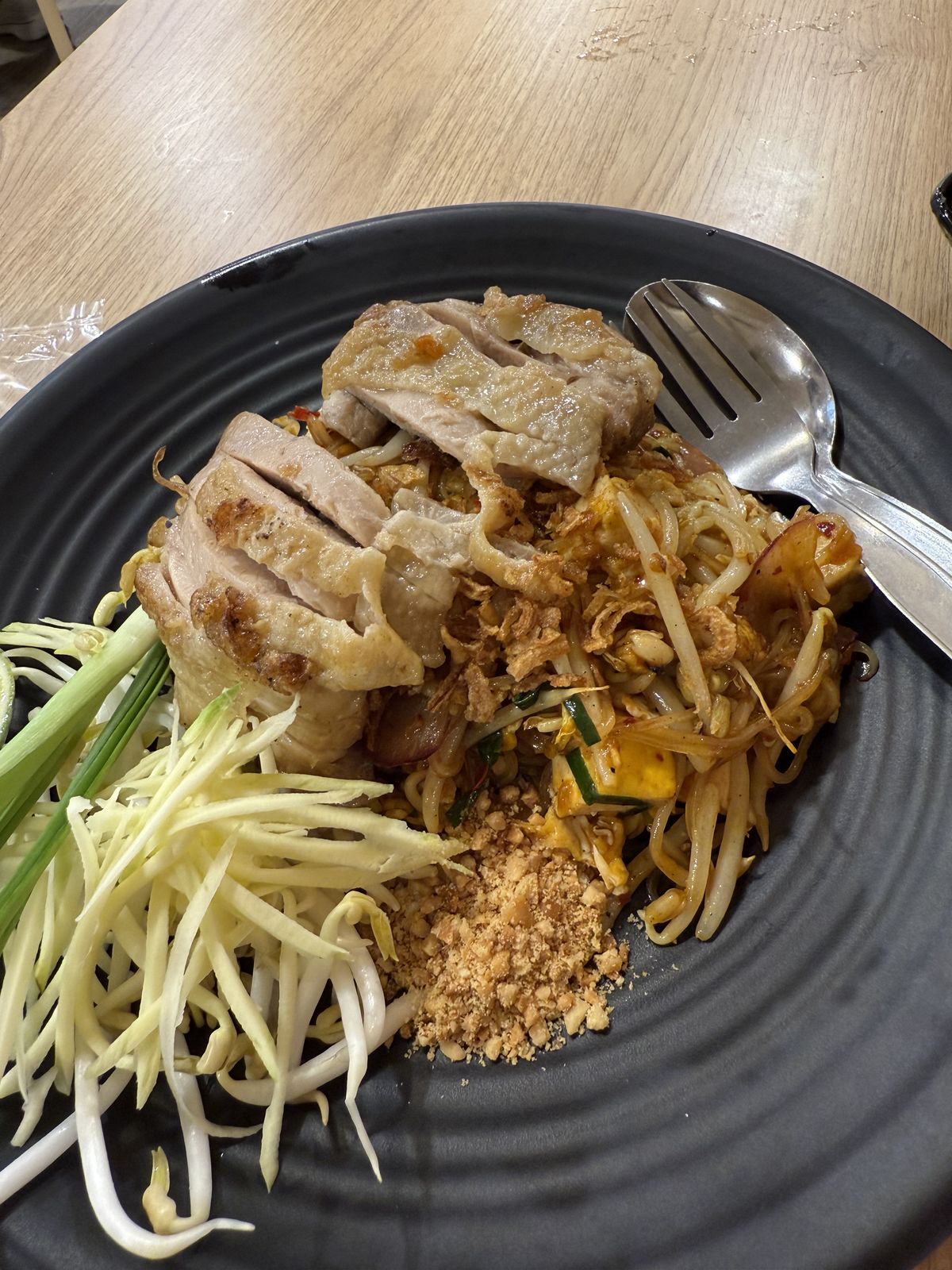 Pad thai with duck on a black plate at a Chiang Mai restaurant